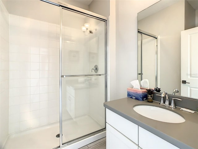 bathroom with walk in shower and vanity