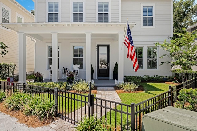 view of front of property featuring a porch and a front lawn