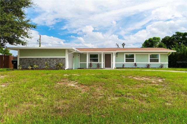 5709 Ridgeway Dr, Orlando, FL 32819 - ranch-style home featuring fence, a front lawn, and stucco siding