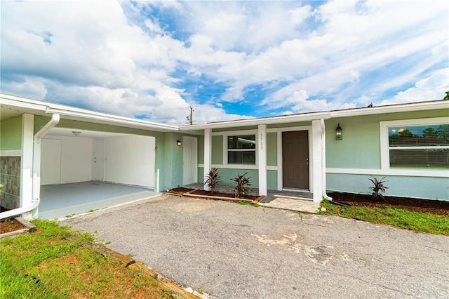 5709 Ridgeway Dr, Orlando, FL 32819 - doorway to property featuring stucco siding and driveway