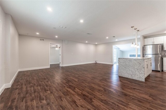 5709 Ridgeway Dr, Orlando, FL 32819 - unfurnished living room with dark wood-style floors, baseboards, visible vents, recessed lighting, and ceiling fan