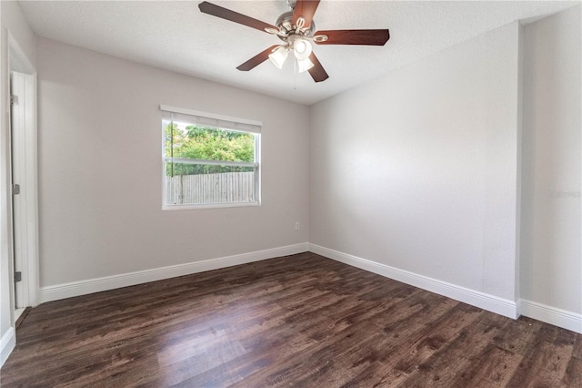 spare room featuring dark hardwood / wood-style floors, a textured ceiling, and ceiling fan