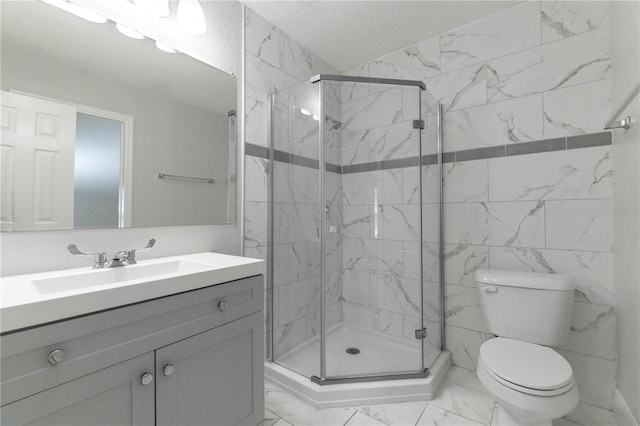 bathroom with vanity, toilet, a textured ceiling, and an enclosed shower