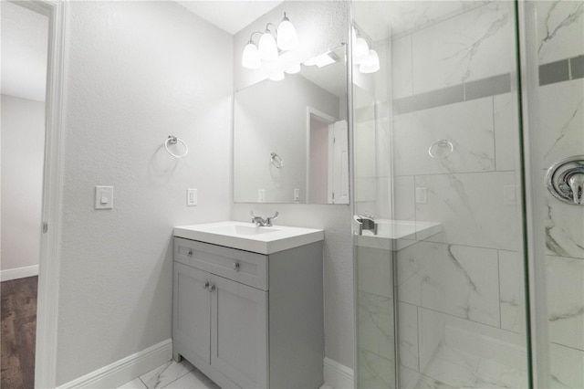 bathroom with a shower with door and vanity