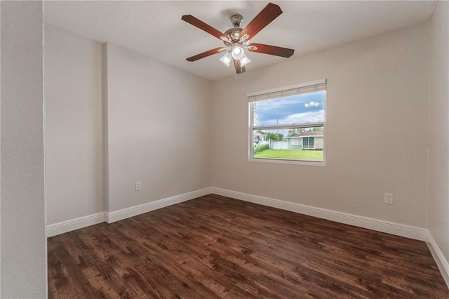 spare room with ceiling fan and dark hardwood / wood-style floors