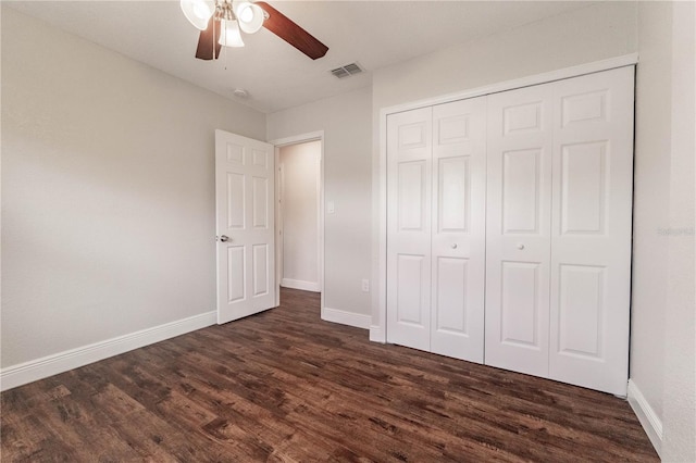 unfurnished bedroom featuring a closet, ceiling fan, and dark hardwood / wood-style floors