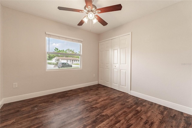 unfurnished bedroom featuring a closet, ceiling fan, and dark hardwood / wood-style floors