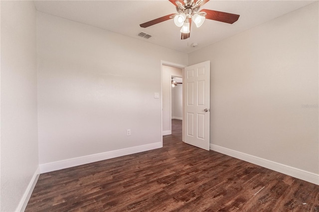 unfurnished room with dark hardwood / wood-style floors and ceiling fan