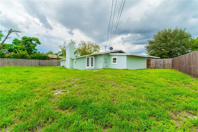 back of property featuring a lawn