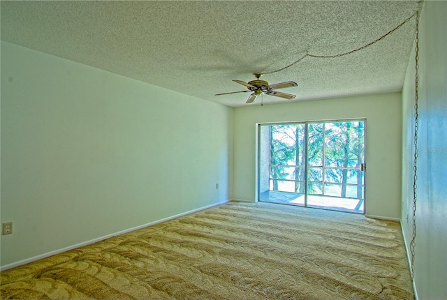 unfurnished room featuring ceiling fan, light colored carpet, and a textured ceiling