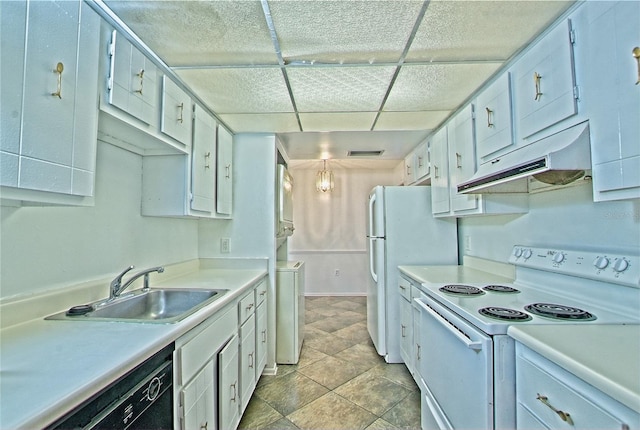 kitchen featuring electric stove, stacked washer / dryer, white cabinetry, and sink