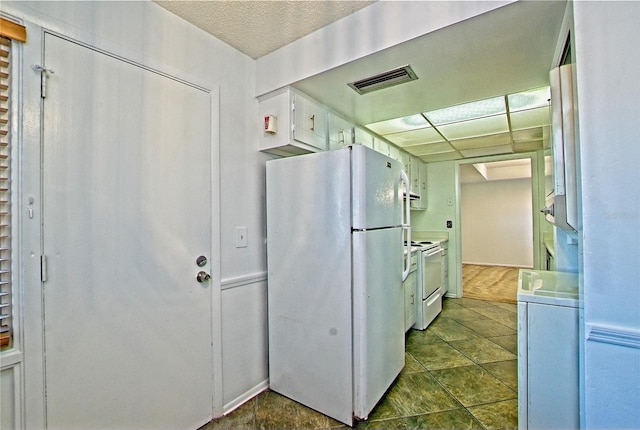 kitchen featuring white appliances and washer / clothes dryer