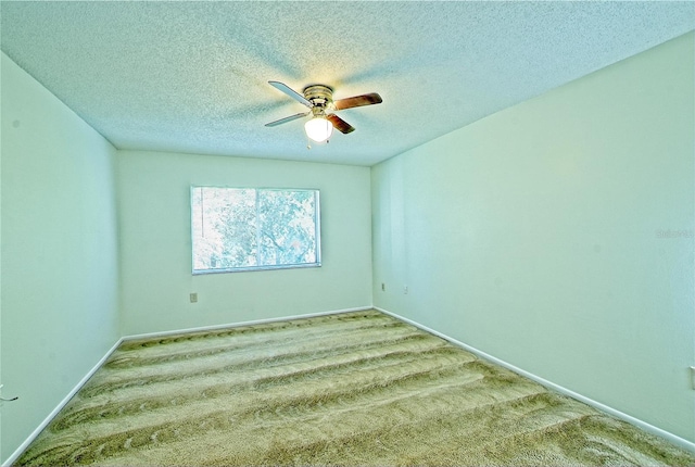 spare room featuring light carpet, a textured ceiling, and ceiling fan