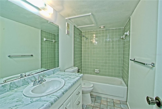 full bathroom featuring tiled shower / bath combo, vanity, and toilet