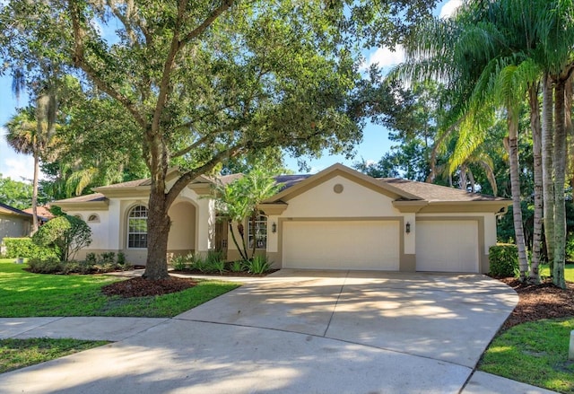 view of front of home featuring a front lawn and a garage