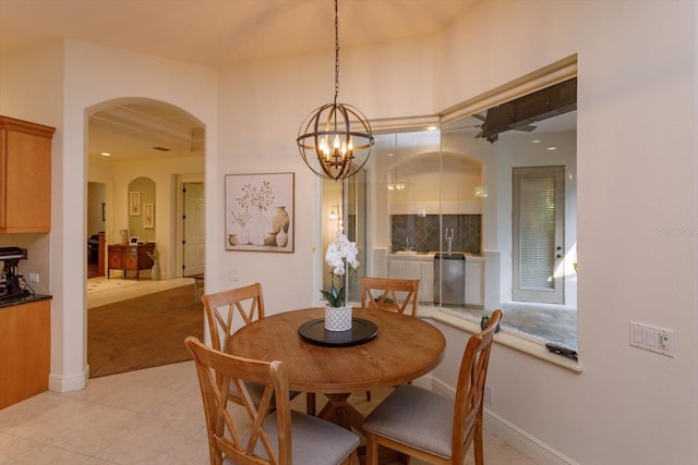 dining area featuring an inviting chandelier and light tile patterned flooring