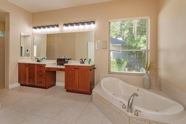 bathroom with a relaxing tiled tub, tile patterned floors, plenty of natural light, and vanity