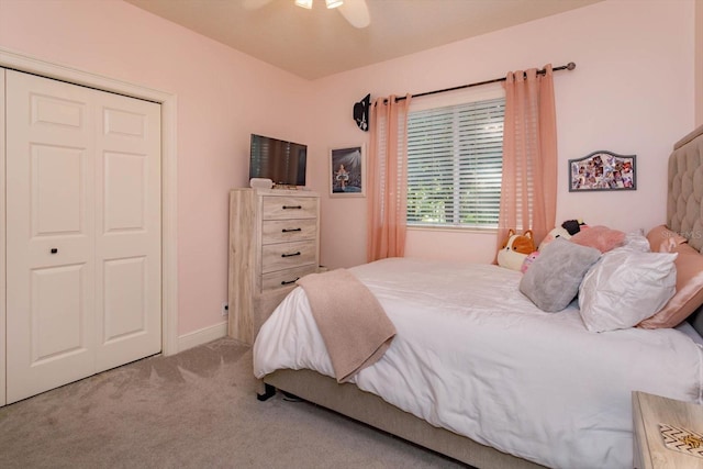 carpeted bedroom with ceiling fan and a closet