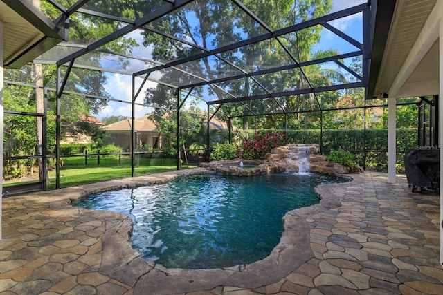 view of pool with a patio, a lanai, and pool water feature