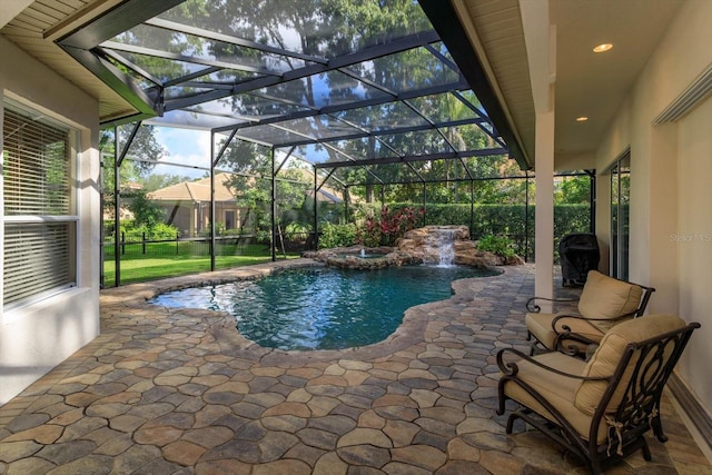 view of pool with pool water feature, a patio, and glass enclosure