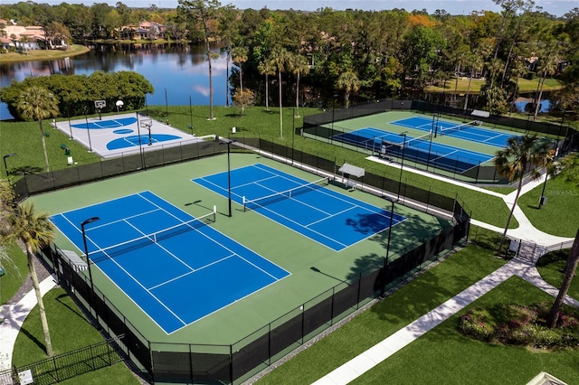 view of sport court featuring a yard and a water view