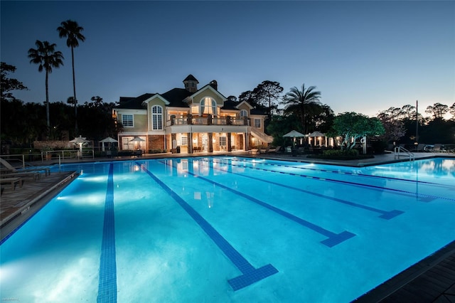 view of pool at dusk