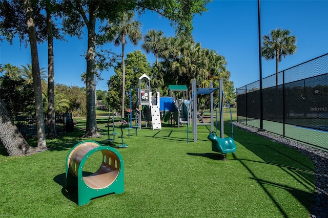 view of jungle gym featuring a lawn