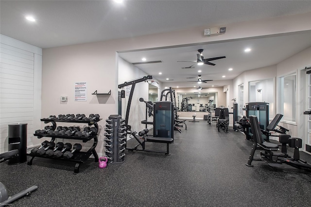 workout area with ceiling fan and a textured ceiling