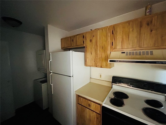 kitchen featuring stove and white fridge