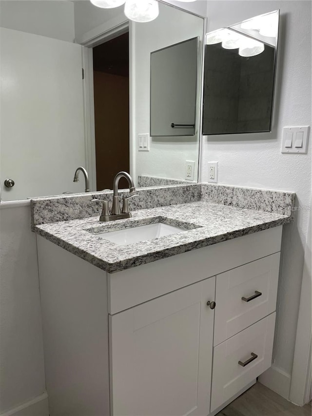 bathroom with vanity and hardwood / wood-style floors