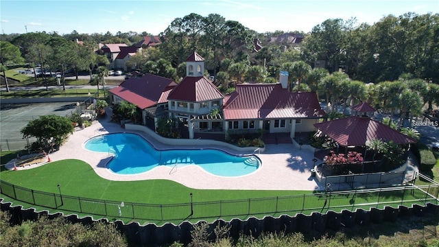 view of pool with a patio and a lawn