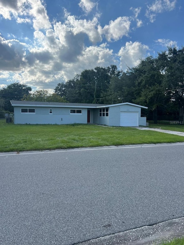 view of front facade with a front lawn and a garage