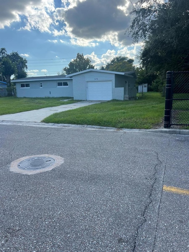 view of front of house featuring a garage and a front lawn