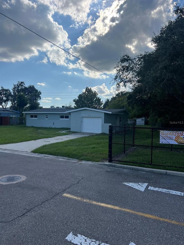 view of front of home featuring a garage and a front yard