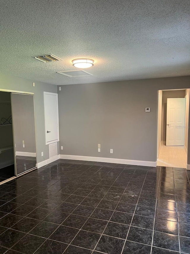 empty room with a textured ceiling