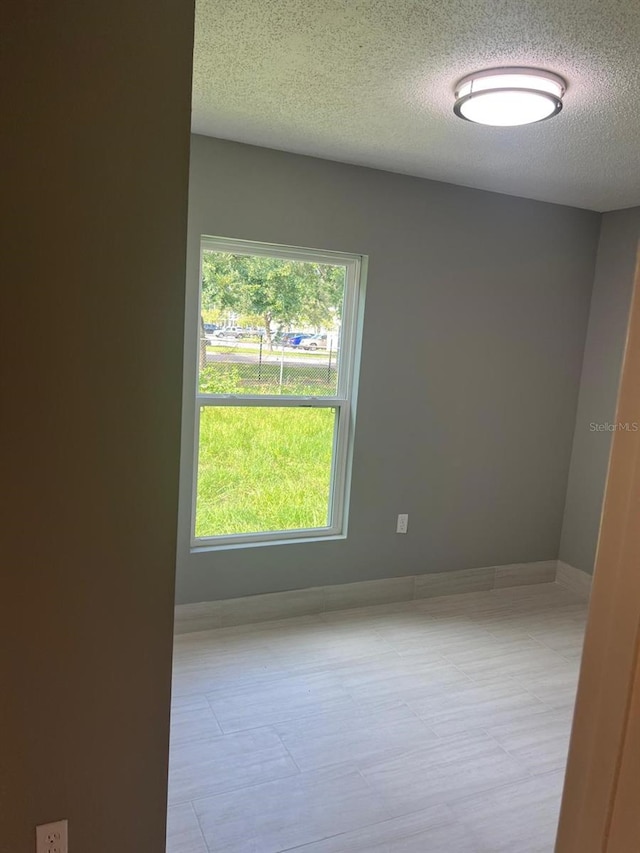 spare room with a textured ceiling