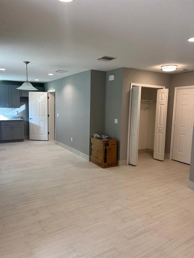 interior space with light hardwood / wood-style flooring and a textured ceiling