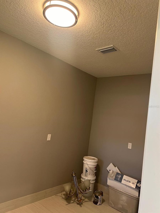 interior space with hardwood / wood-style floors and a textured ceiling