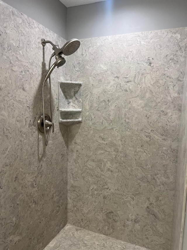 bathroom with a tile shower