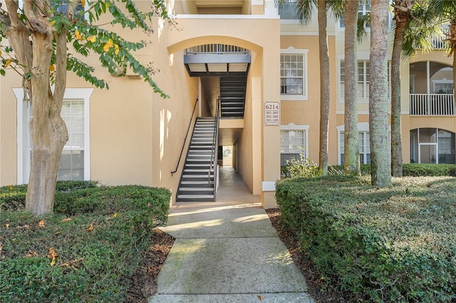 view of exterior entry featuring a balcony