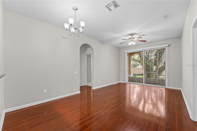 spare room featuring ceiling fan with notable chandelier and dark hardwood / wood-style floors