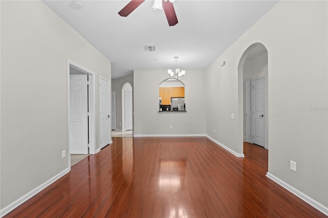 unfurnished room with ceiling fan with notable chandelier and dark hardwood / wood-style floors