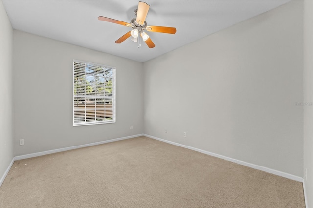 empty room with ceiling fan and light colored carpet