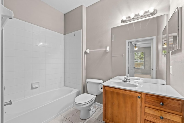 full bathroom with tile patterned flooring, vanity, ceiling fan, tiled shower / bath, and toilet