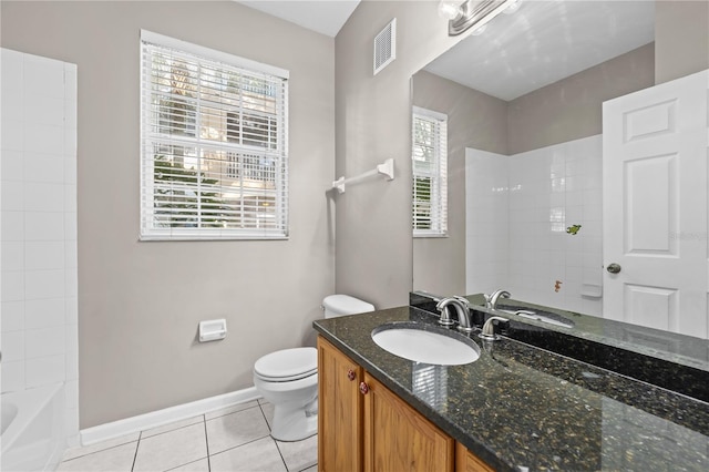 full bathroom with tiled shower / bath, vanity, toilet, and tile patterned floors