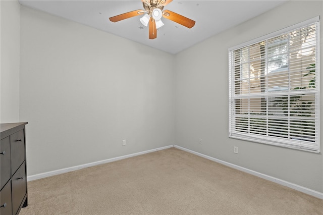 unfurnished room featuring light carpet and ceiling fan