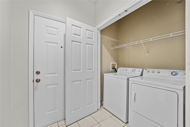 laundry area with light tile patterned floors and washing machine and dryer