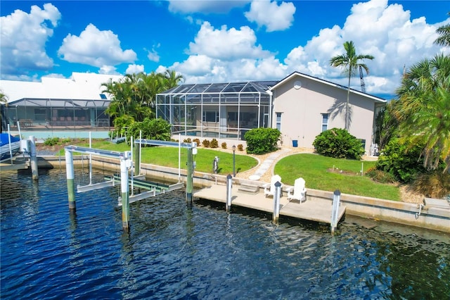 view of dock featuring a lanai, a water view, and a lawn