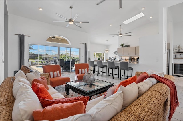 tiled living room featuring high vaulted ceiling, ceiling fan, and beverage cooler