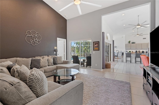 living room with high vaulted ceiling, light tile patterned floors, and ceiling fan